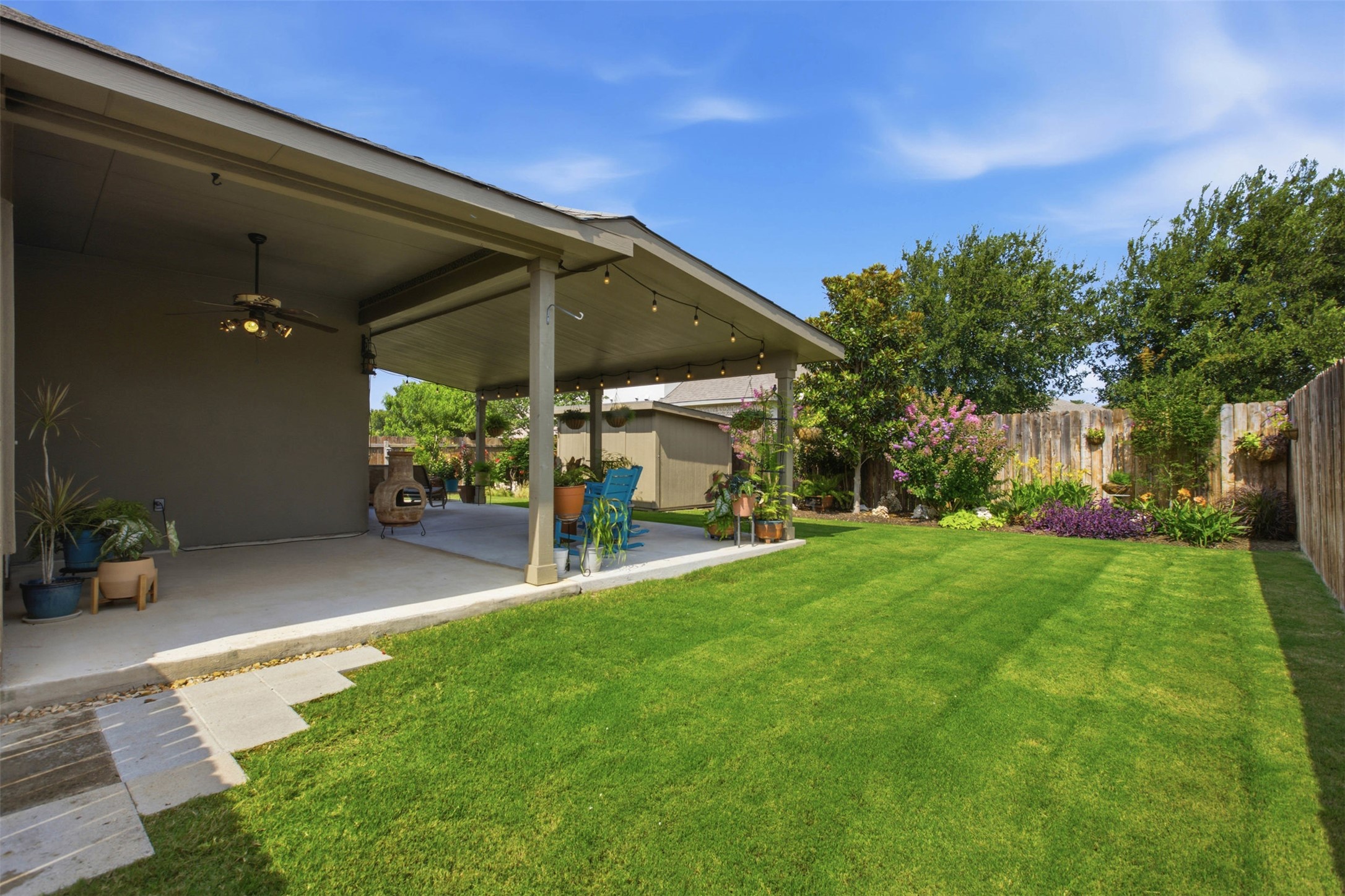 2413 Bridges Ranch Road Georgetown, TX 78628 - Photo 25 of 31 A well-maintained lawn unfolds to a generous covered patio, perfect for outdoor relaxation and entertaining.
