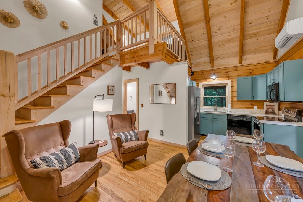192 Dewitt Barnett Road Vilas, NC 28692 - Photo 5 of 32 a living room with furniture a fireplace and a ceiling fan