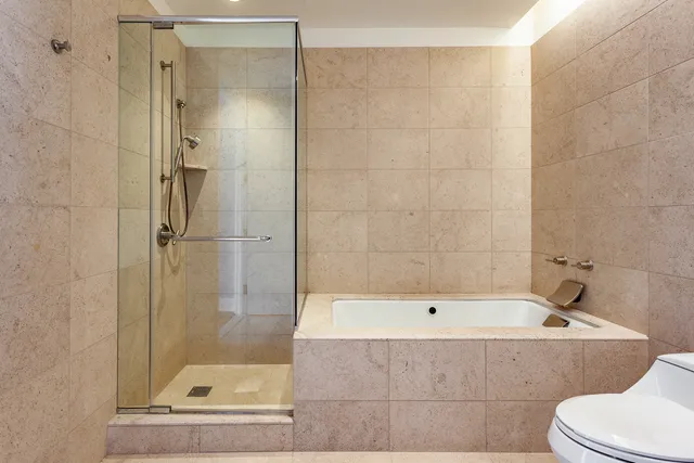 a bathroom with a bathtub and a shower