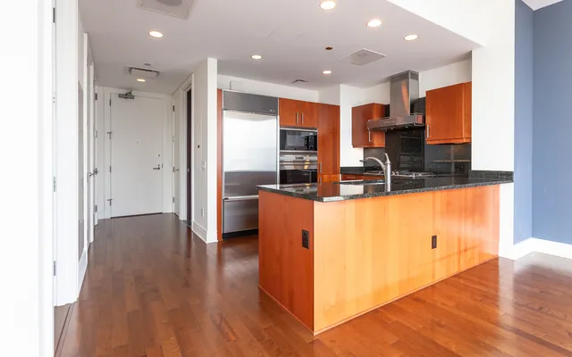 a view of kitchen with cabinets and wooden floor