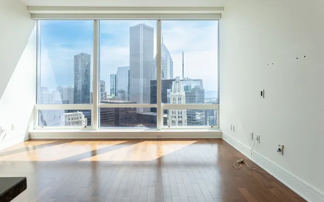 a view of a room with wooden floor and windows