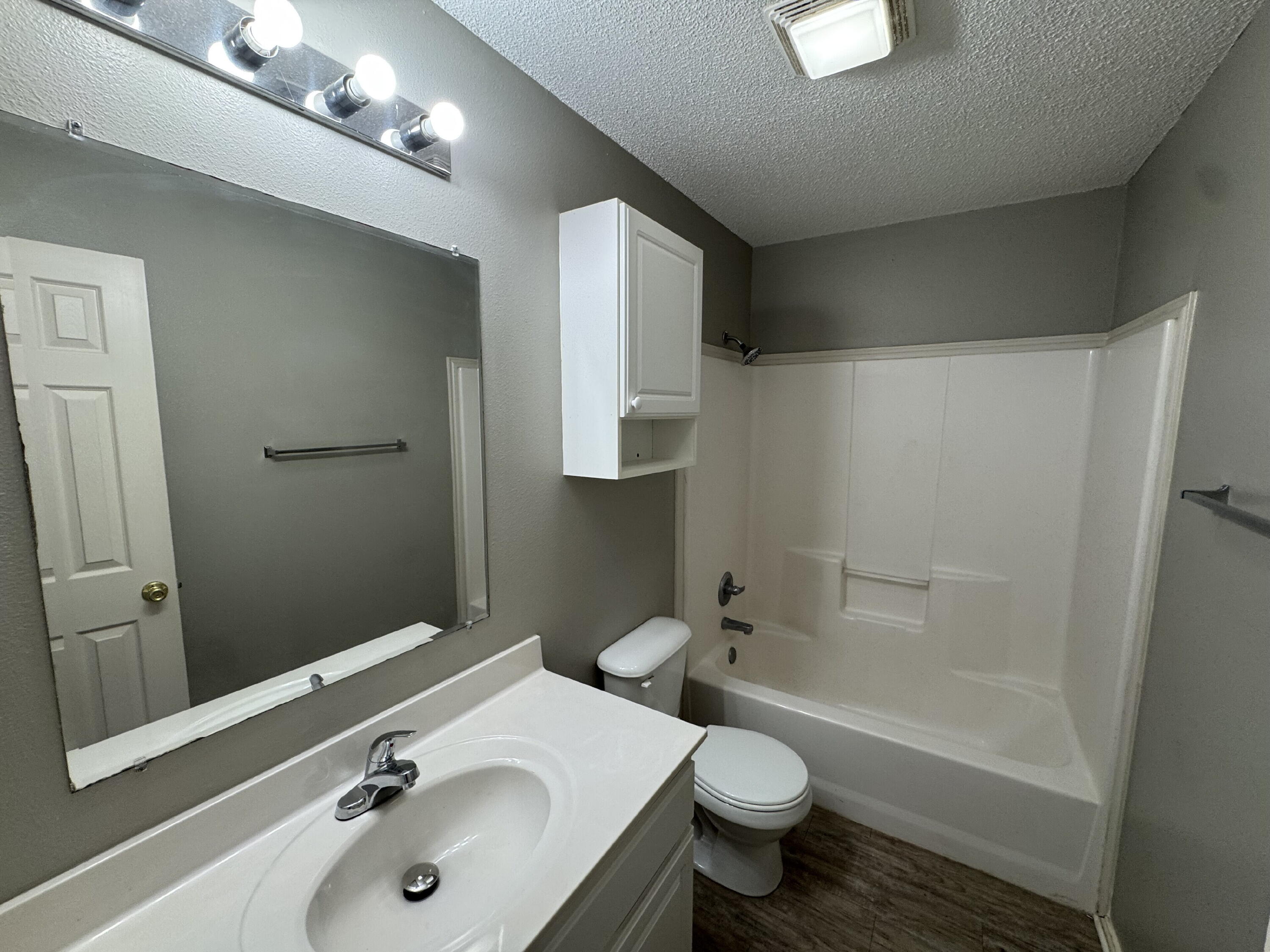 5839 7th Street, Unit D Lubbock, TX 79416 - Photo 9 of 9 a bathroom with a sink toilet and shower