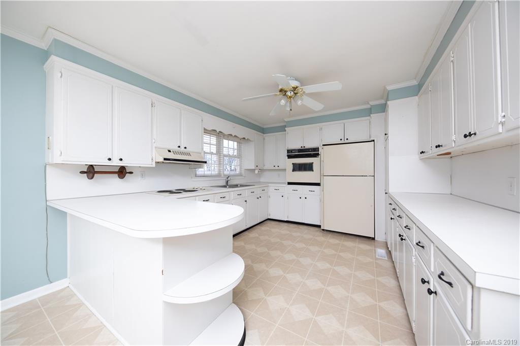 3780 Sawmill Road Hickory Grove, SC 29717 - Photo 25 of 35 a kitchen with kitchen island a sink appliances and cabinets