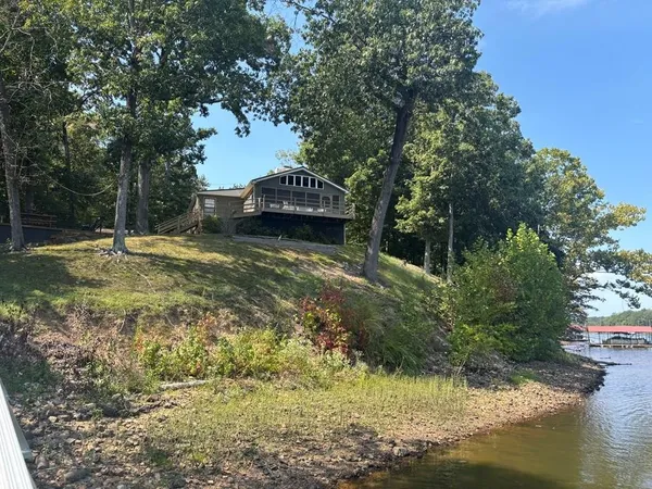 a view of a lake with a house in the background