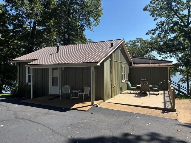 a front view of a house with yard and seating space
