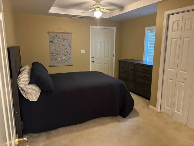 a bedroom with a bed and cabinets