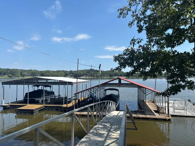 a view of a house with pool and sitting area