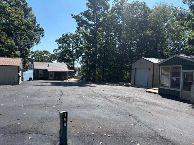 a front view of a house with a yard and parking space
