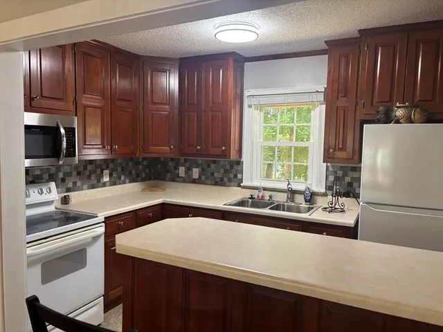 a kitchen with a refrigerator and a sink
