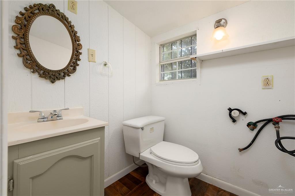 218 East Sam Houston Boulevard Pharr, TX 78577 - Photo 17 of 25 a bathroom with a sink a toilet and a mirror