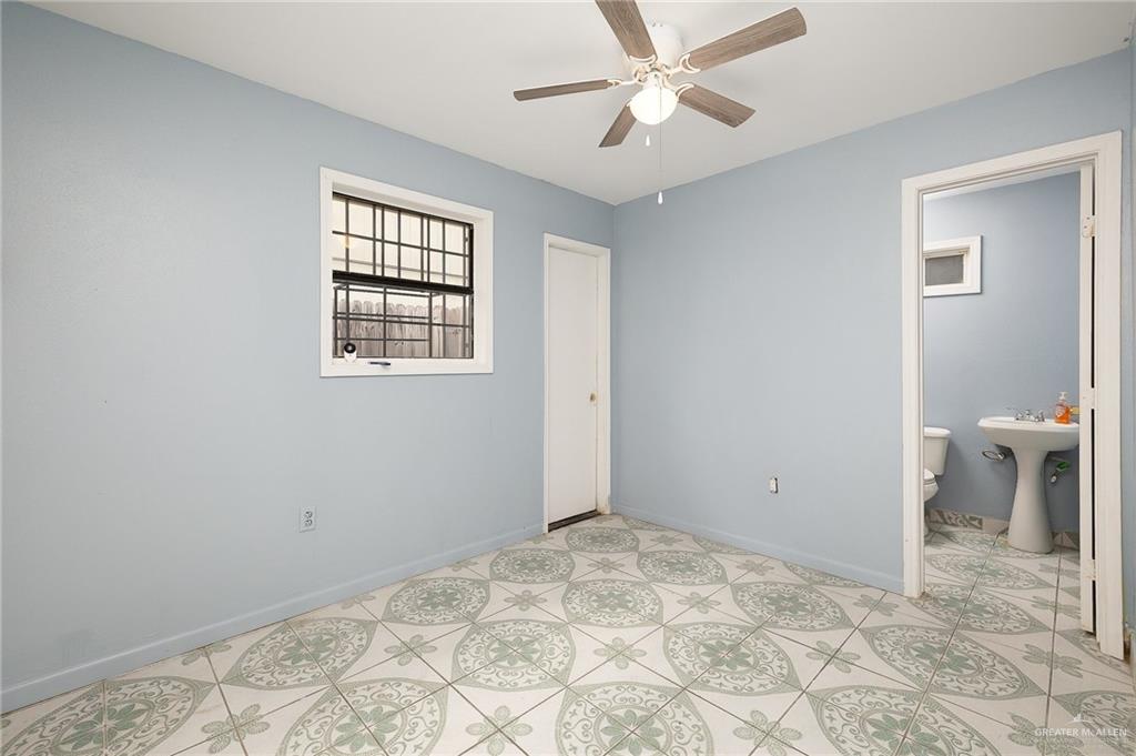 218 East Sam Houston Boulevard Pharr, TX 78577 - Photo 18 of 25 a view of a room with a ceiling fan and a window