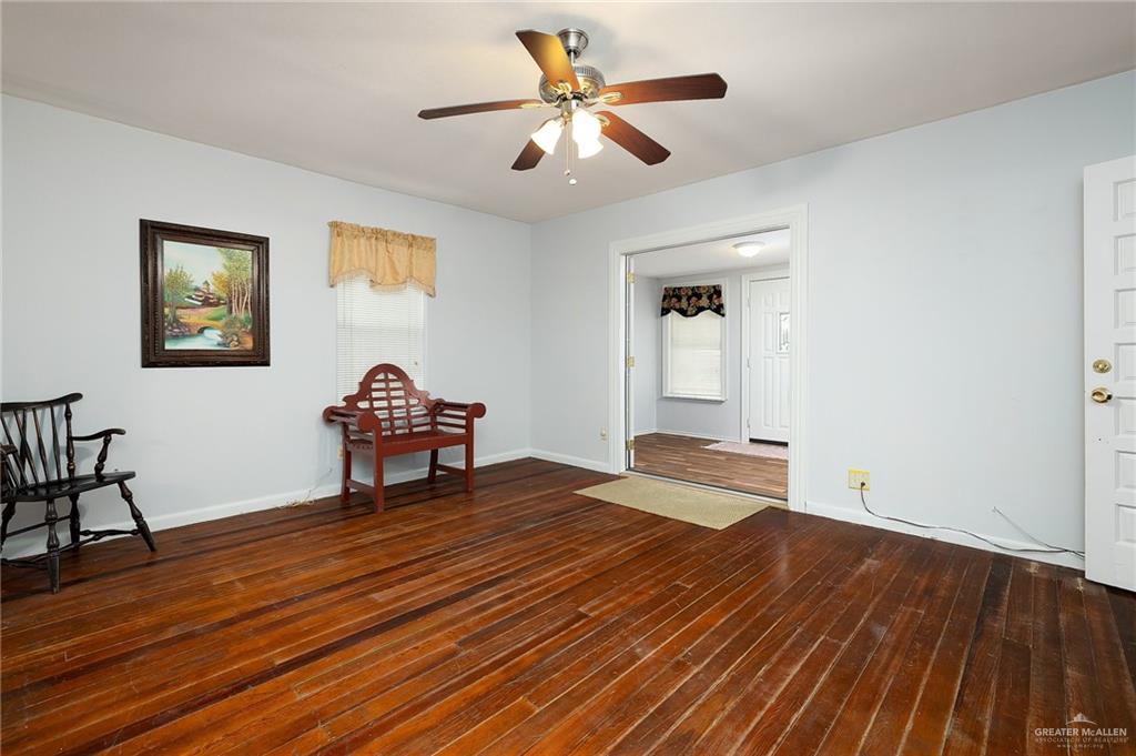 218 East Sam Houston Boulevard Pharr, TX 78577 - Photo 3 of 25 a bedroom with a bed and a chandelier