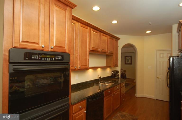 2622 Monocacy Ford Road Frederick, MD 21701 - Photo 8 of 12 a kitchen with granite countertop a stove and a refrigerator