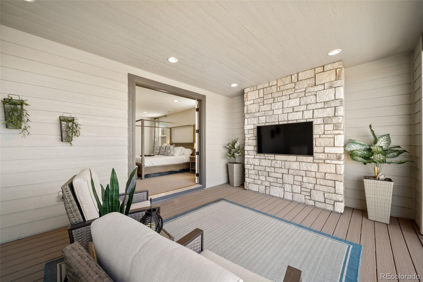6465 Barnstead Drive Castle Pines, CO 80108 - Photo 14 of 50 a living room with furniture and a flat screen tv