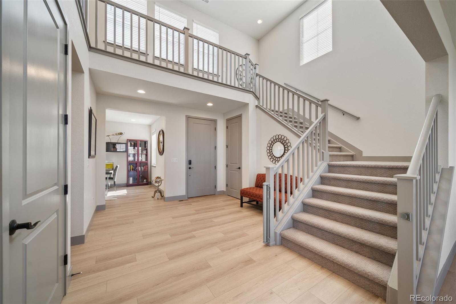 6465 Barnstead Drive Castle Pines, CO 80108 - Photo 15 of 50 a view of staircase with white walls and frames on wall