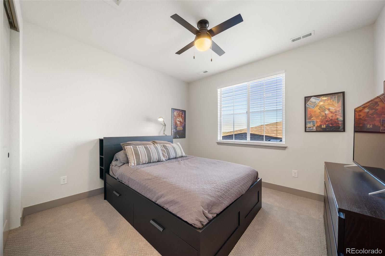 6465 Barnstead Drive Castle Pines, CO 80108 - Photo 28 of 50 a bed room with a bed and a window