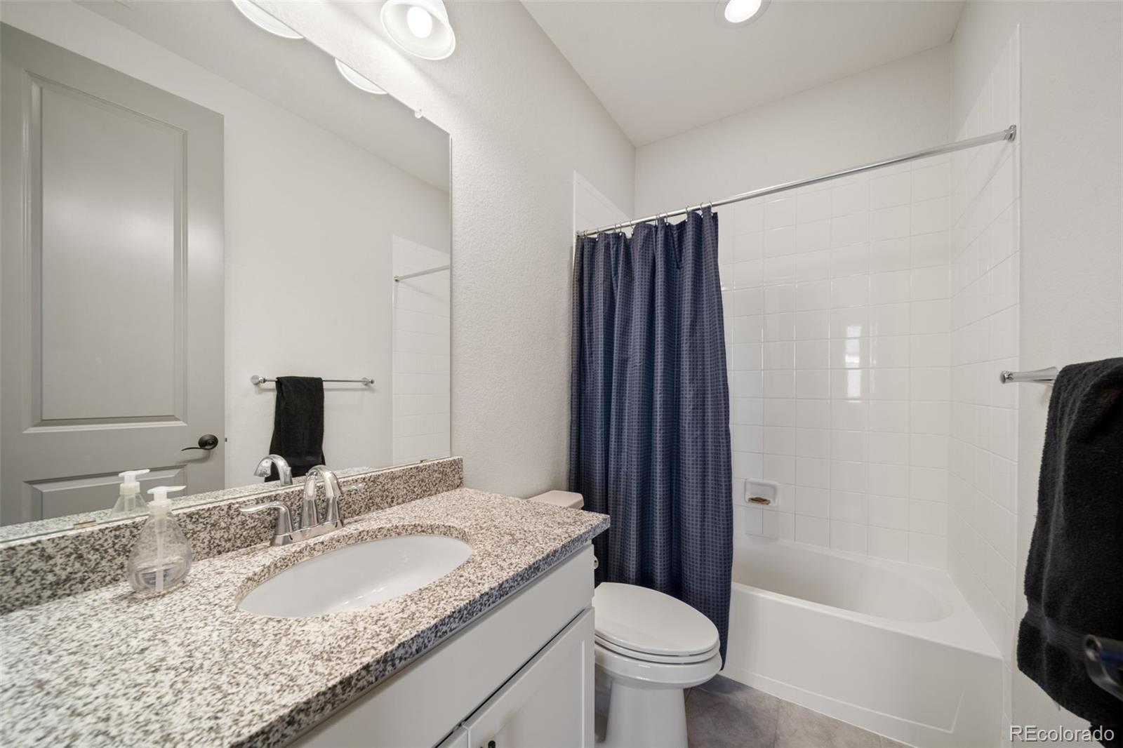 6465 Barnstead Drive Castle Pines, CO 80108 - Photo 29 of 50 a bathroom with a granite countertop sink toilet and shower