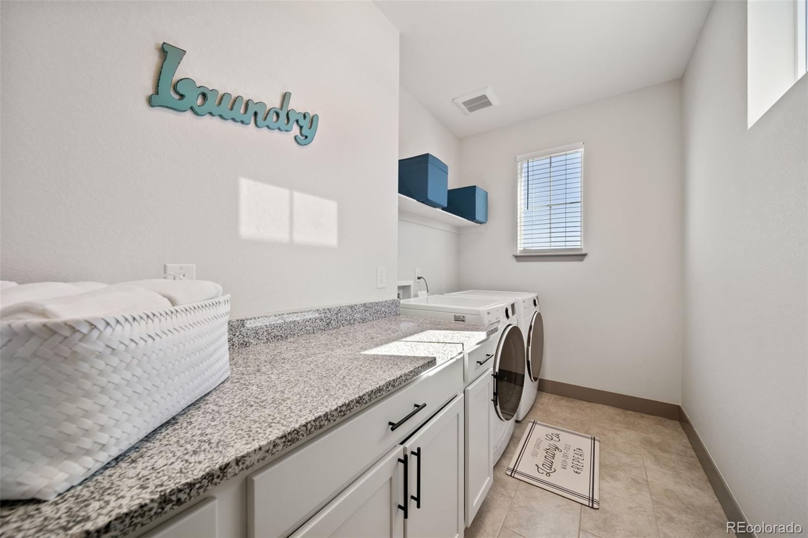 6465 Barnstead Drive Castle Pines, CO 80108 - Photo 30 of 50 a bathroom with a granite countertop sink and a mirror