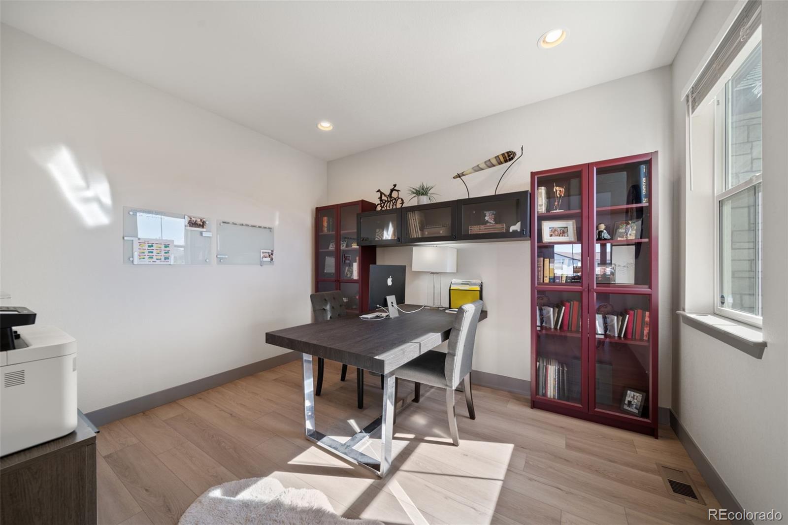 6465 Barnstead Drive Castle Pines, CO 80108 - Photo 32 of 50 a view of a dining room with furniture and wooden floor
