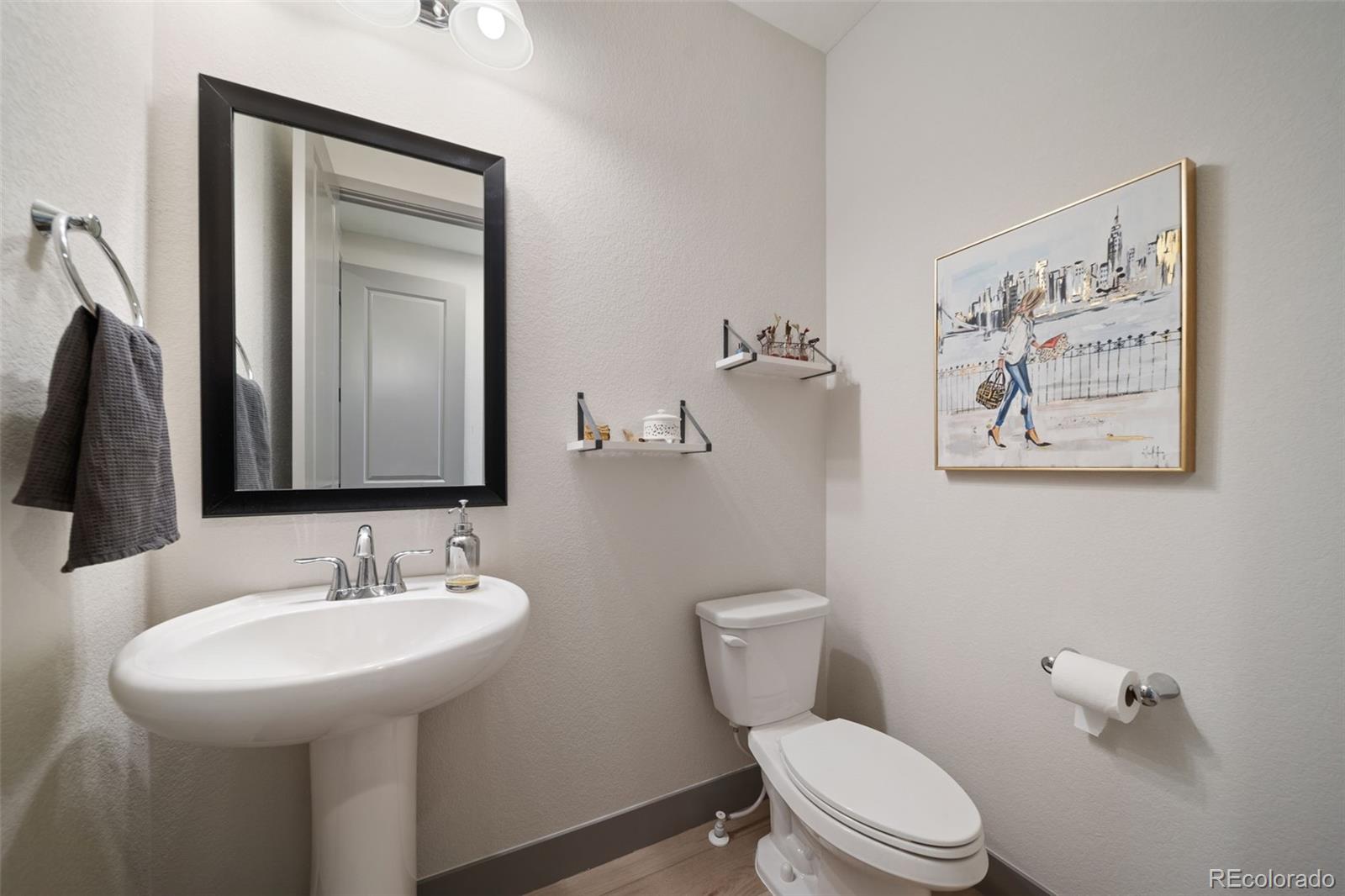 6465 Barnstead Drive Castle Pines, CO 80108 - Photo 34 of 50 a bathroom with a toilet sink and mirror