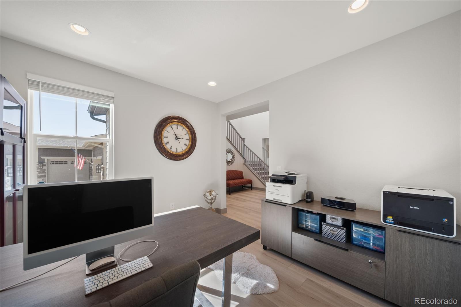 6465 Barnstead Drive Castle Pines, CO 80108 - Photo 35 of 50 a living room with furniture and a flat screen tv
