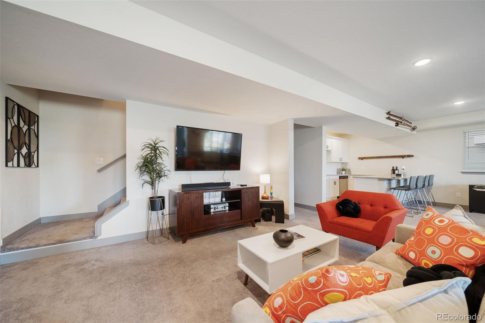 6465 Barnstead Drive Castle Pines, CO 80108 - Photo 36 of 50 a living room with furniture and a flat screen tv