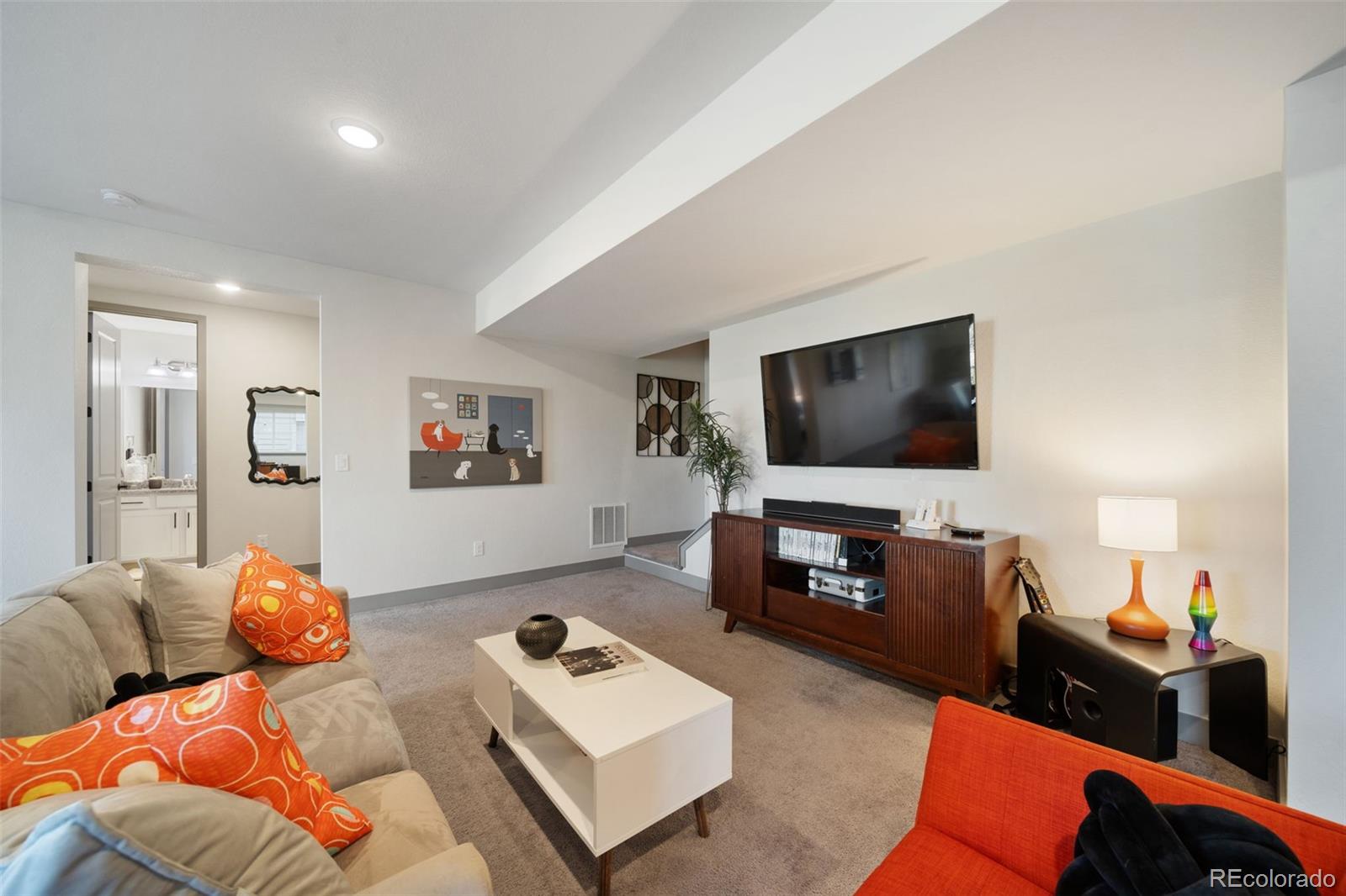 6465 Barnstead Drive Castle Pines, CO 80108 - Photo 37 of 50 a living room with furniture and a flat screen tv