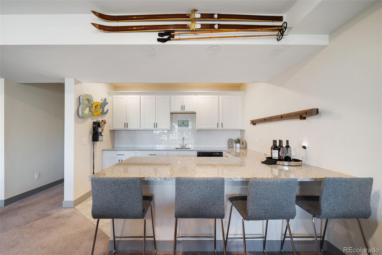 6465 Barnstead Drive Castle Pines, CO 80108 - Photo 40 of 50 a kitchen with a dining table chairs and white appliances