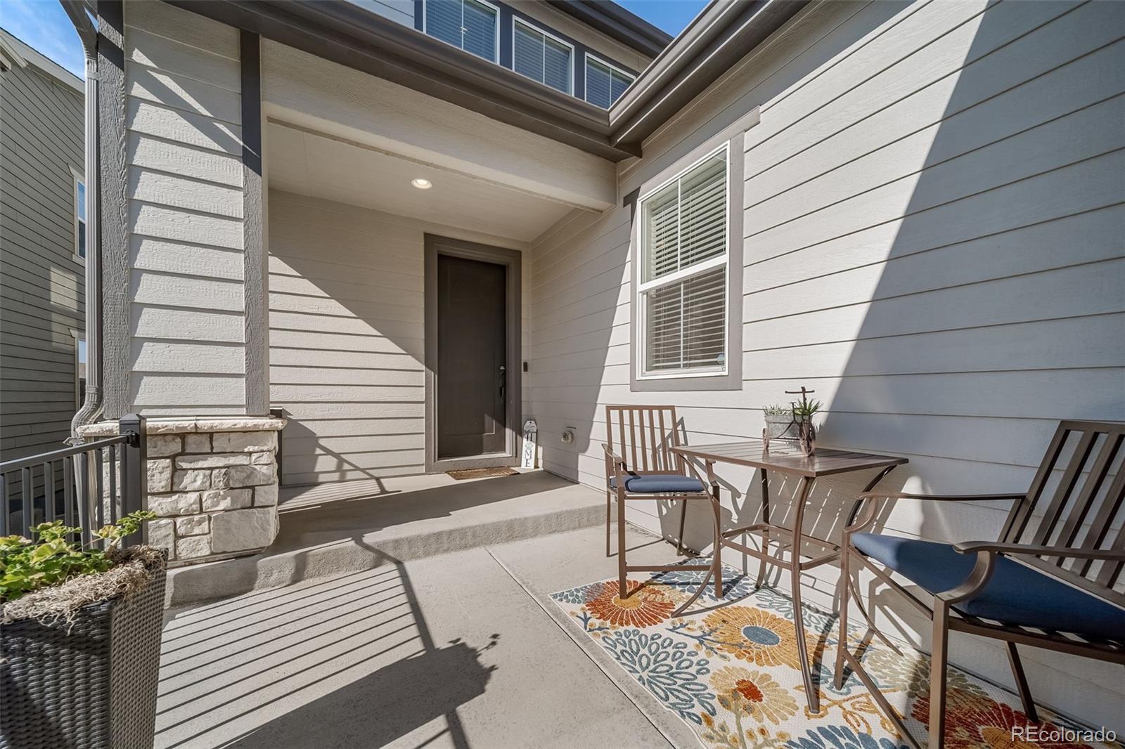 6465 Barnstead Drive Castle Pines, CO 80108 - Photo 4 of 50 a view of a patio with table and chairs with wooden floor and fence