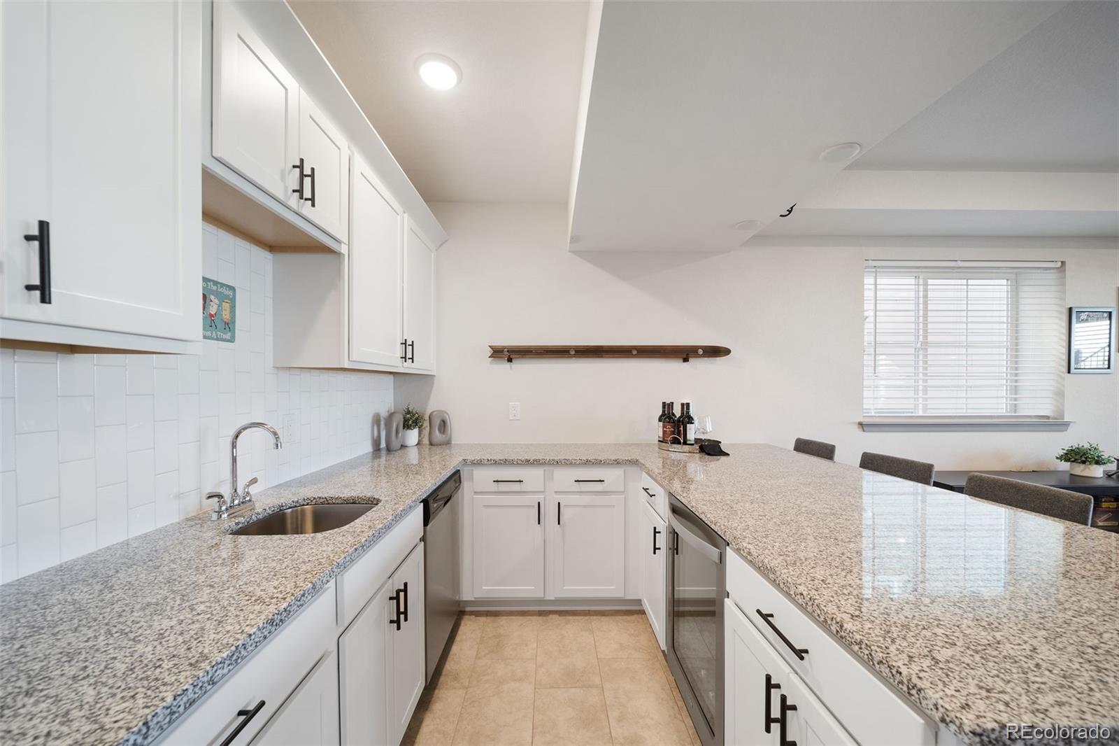 6465 Barnstead Drive Castle Pines, CO 80108 - Photo 41 of 50 a kitchen with a sink a stove and cabinets