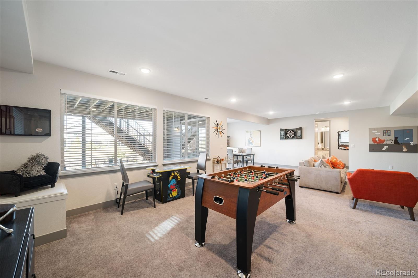 6465 Barnstead Drive Castle Pines, CO 80108 - Photo 42 of 50 a living room with furniture a flat screen tv and a large window