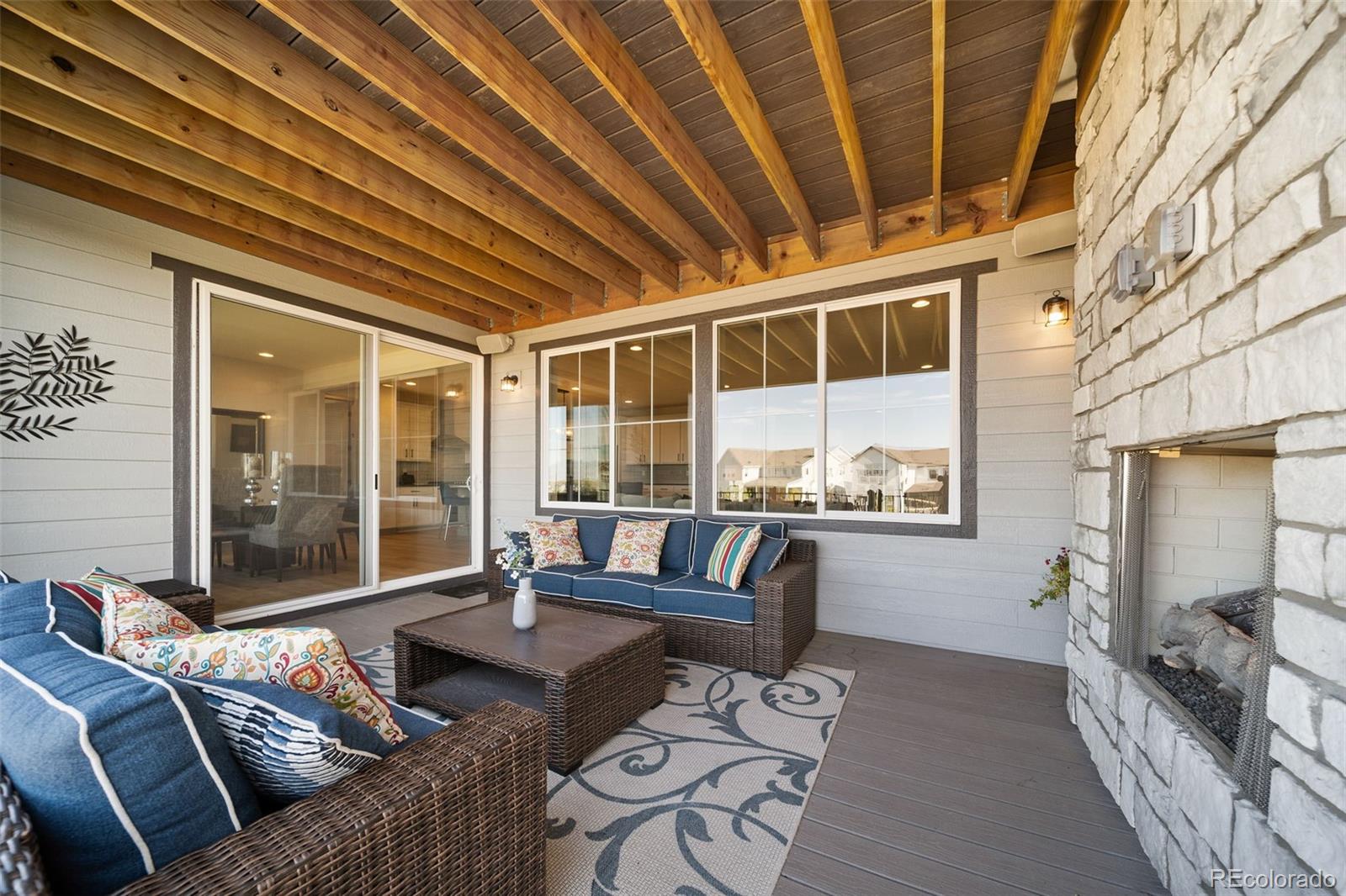 6465 Barnstead Drive Castle Pines, CO 80108 - Photo 46 of 50 a living room with furniture and a floor to ceiling window
