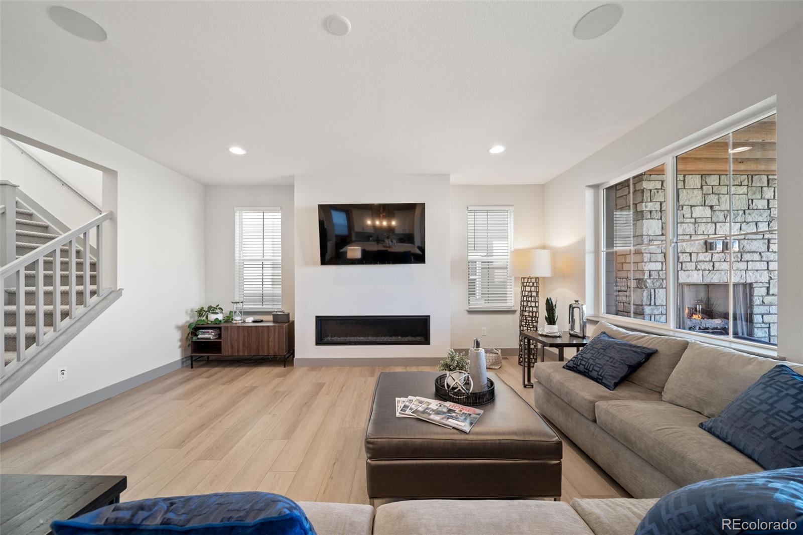 6465 Barnstead Drive Castle Pines, CO 80108 - Photo 5 of 50 a living room with furniture wooden floor and a flat screen tv