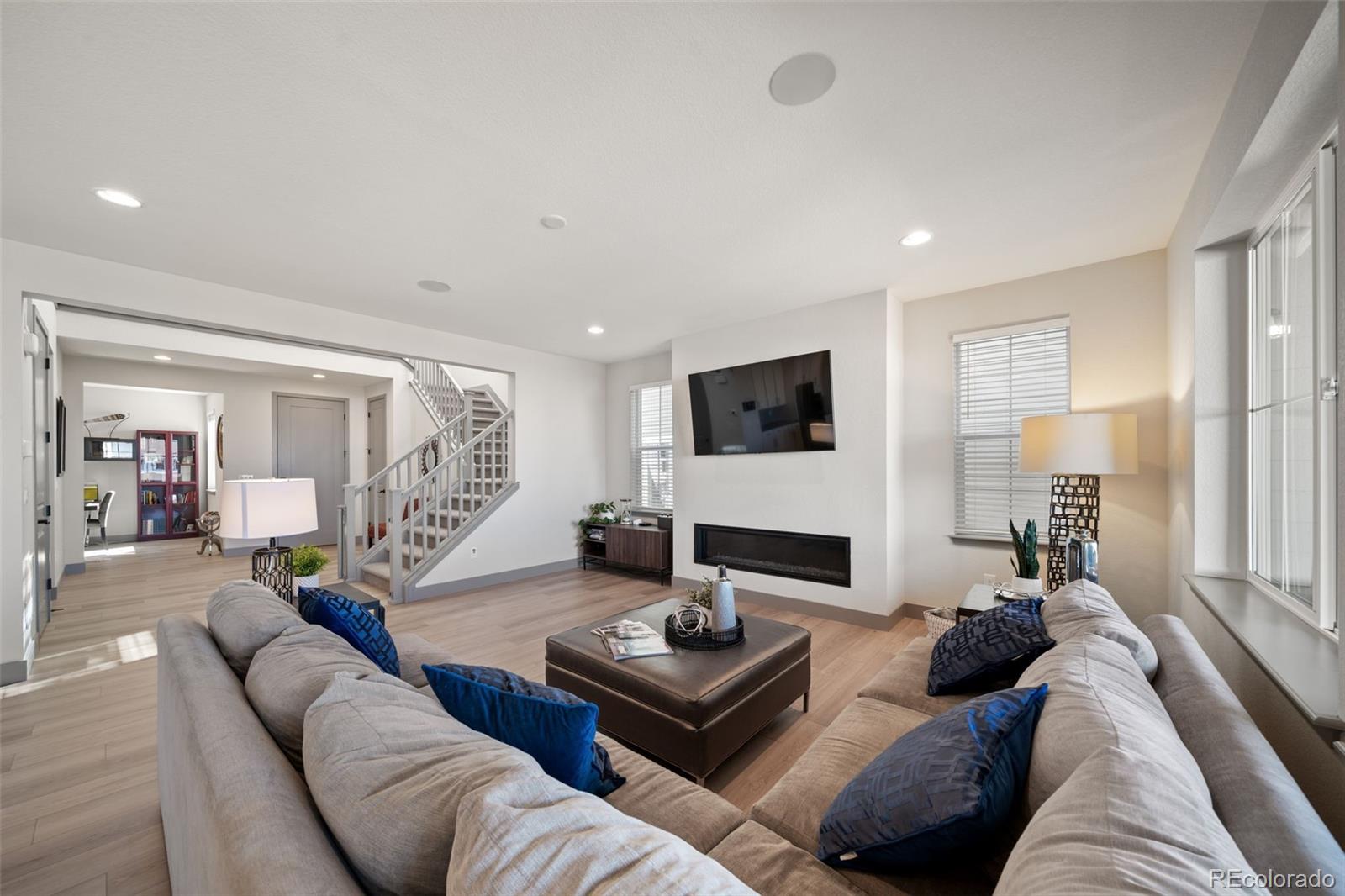 6465 Barnstead Drive Castle Pines, CO 80108 - Photo 6 of 50 a living room with furniture and a flat screen tv