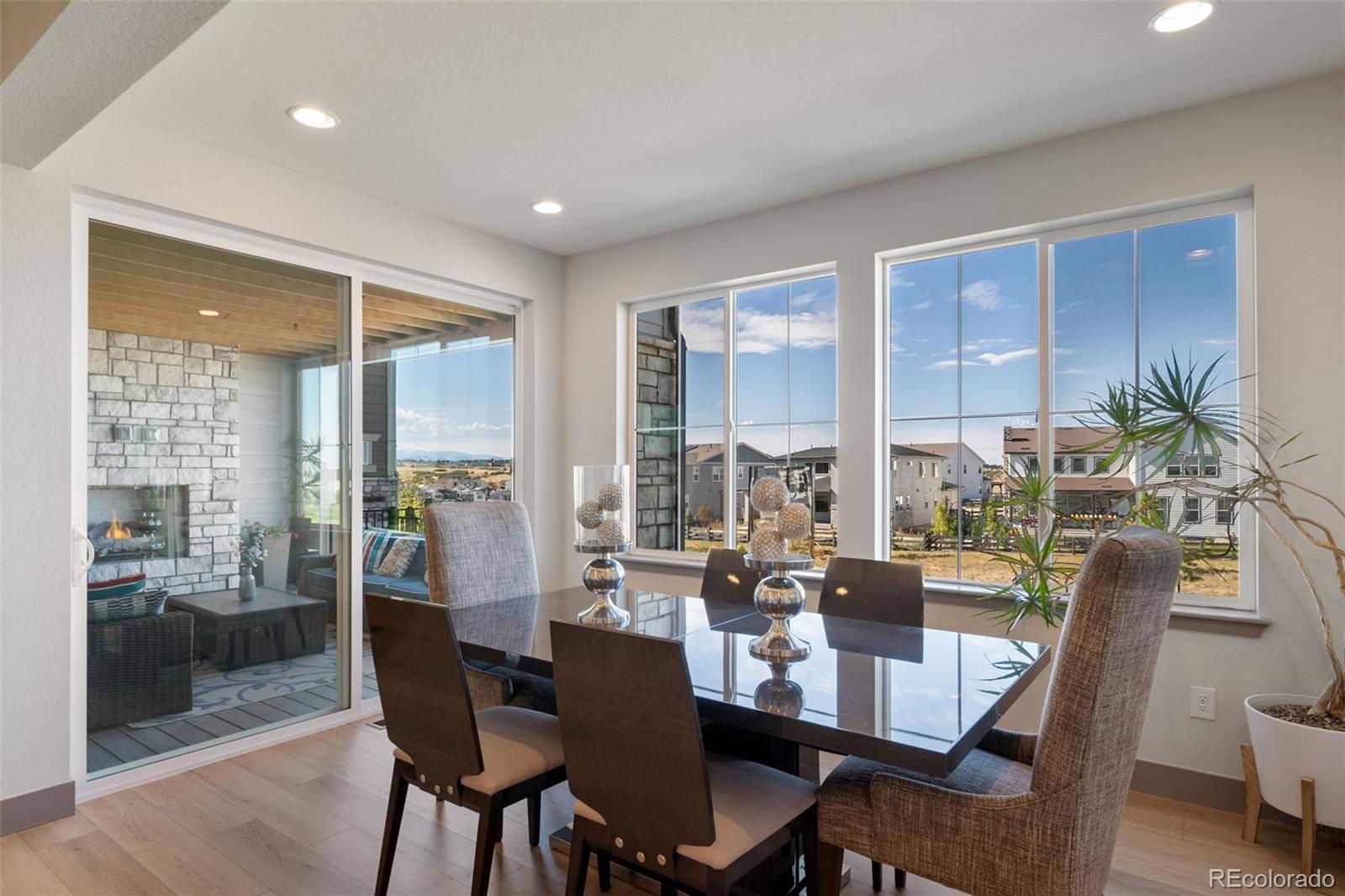 6465 Barnstead Drive Castle Pines, CO 80108 - Photo 7 of 50 a view of a dining room with furniture window and wooden floor