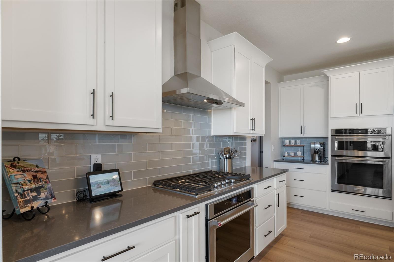 6465 Barnstead Drive Castle Pines, CO 80108 - Photo 8 of 50 a kitchen with granite countertop a stove and a sink