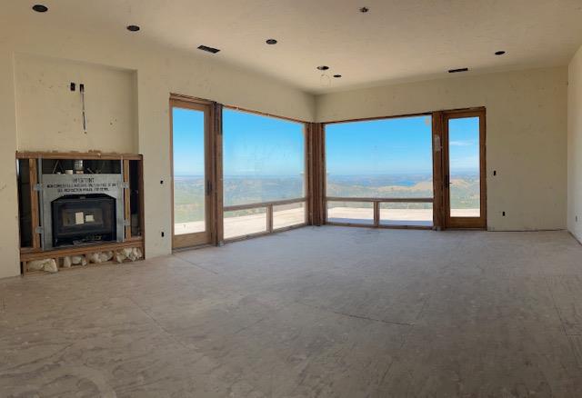 15169 Moccasin Ranch Road Coulterville, CA 95311 - Photo 12 of 15 a view of an empty room with a fireplace and a window