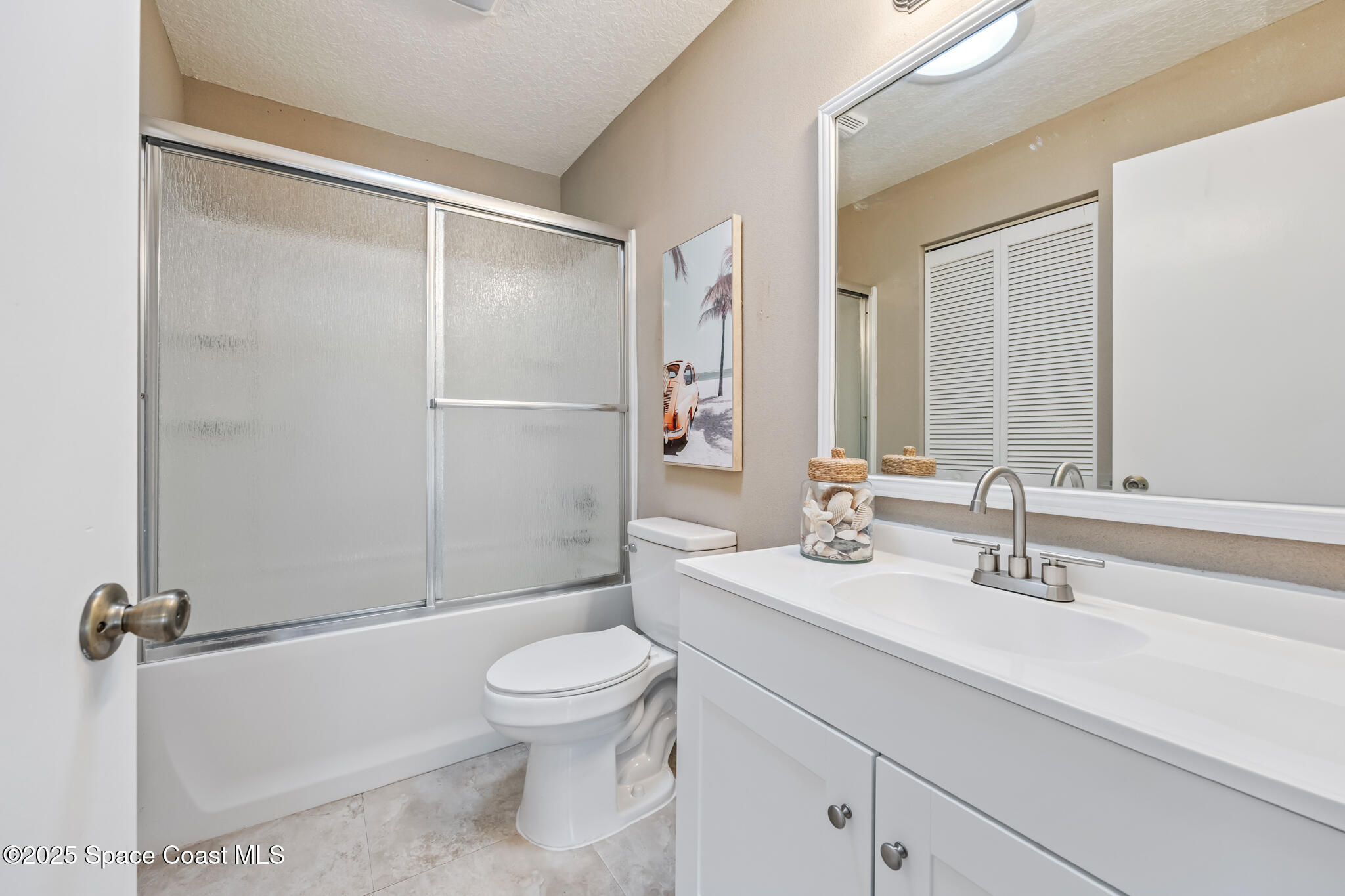 286 Alegriano Road Northwest Palm Bay, FL 32907 - Photo 17 of 24 a bathroom with a sink a mirror and a toilet