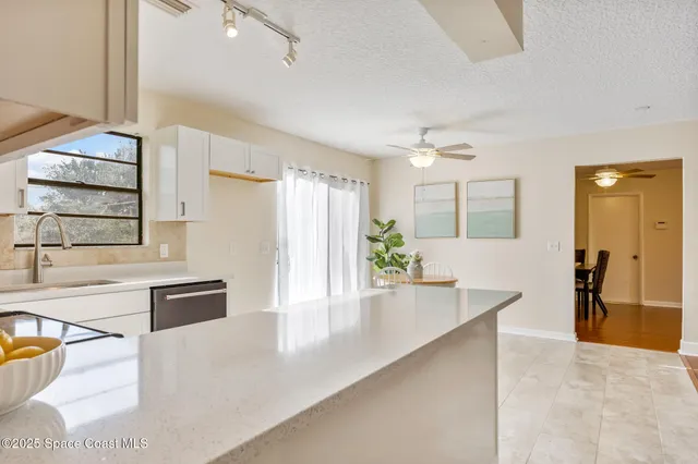 a view of kitchen with stainless steel appliances kitchen island wooden floors and center island