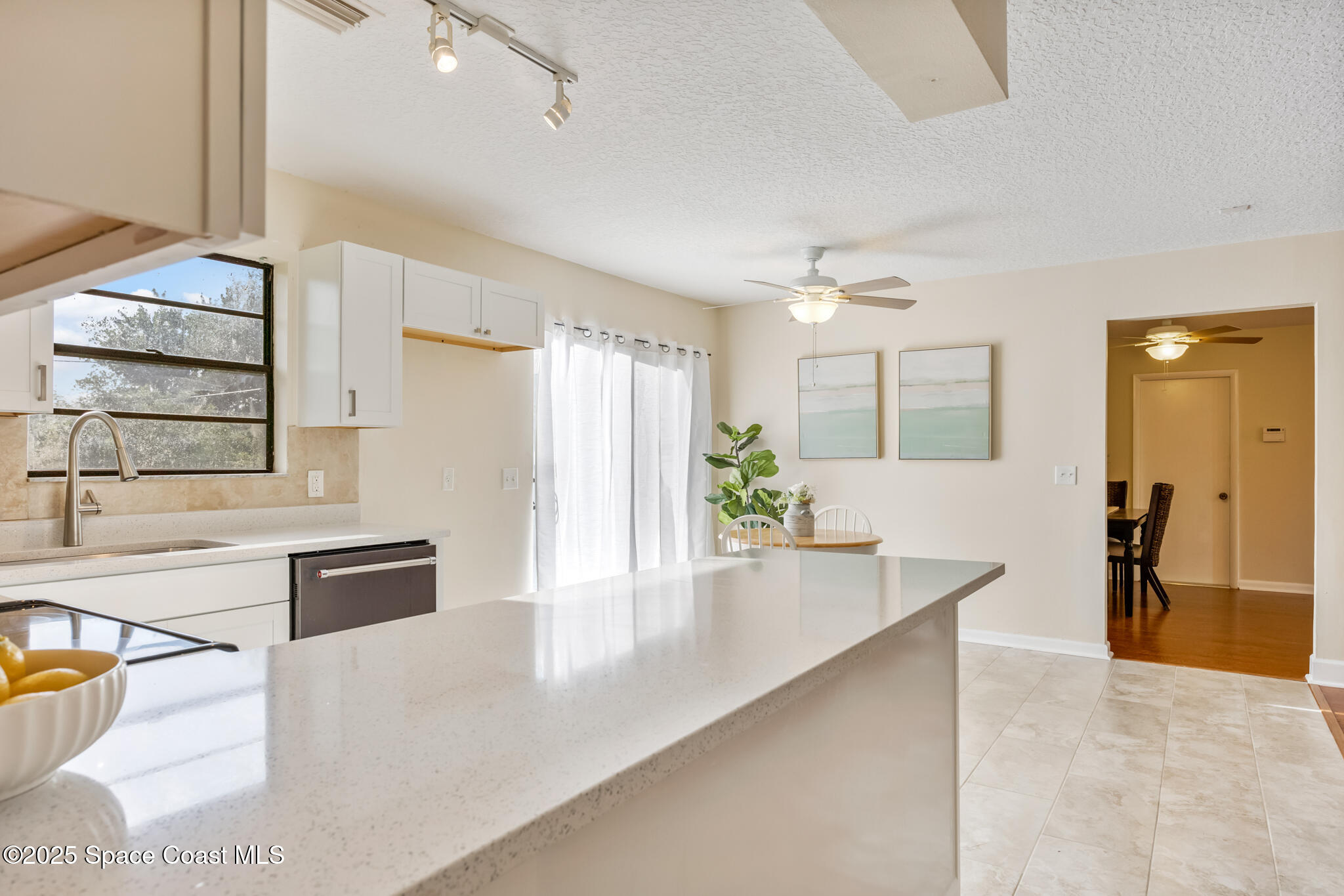 286 Alegriano Road Northwest Palm Bay, FL 32907 - Photo 10 of 24 a large white kitchen with granite countertop a sink and a stove top oven