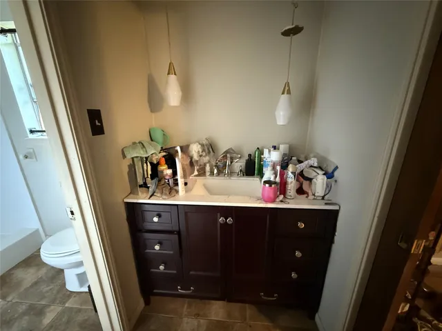 a bedroom with furniture and a chandelier