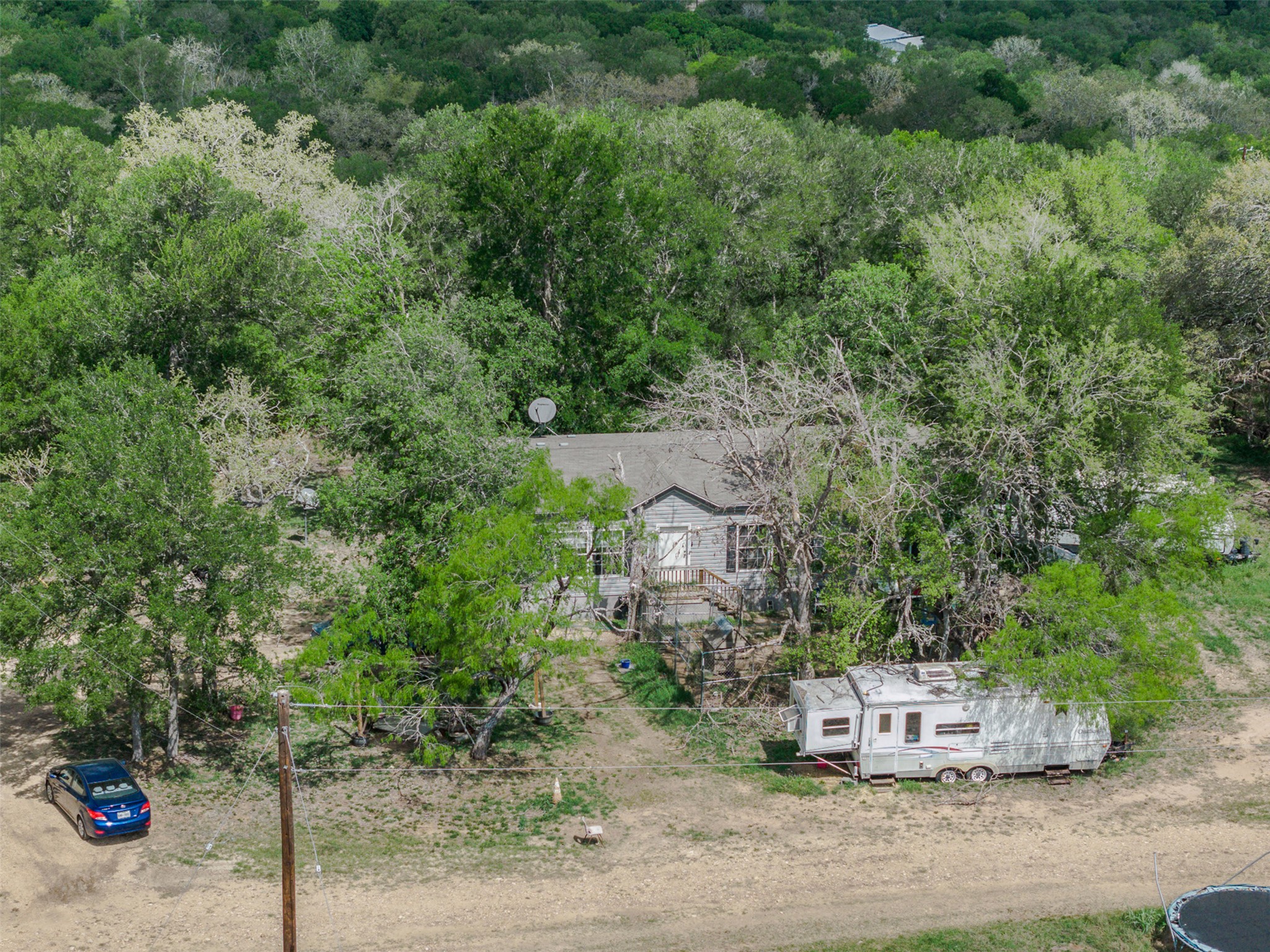 8519 State Park Road Lockhart, TX 78644 - Photo 29 of 40 Aerial view of property and surrounding area with a heavily wooded area