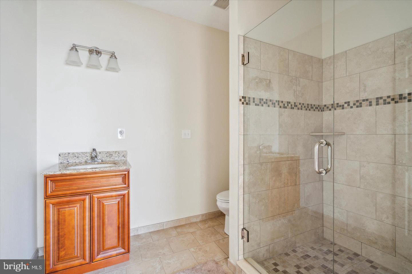 118 Richmond Street, Unit 2B Philadelphia, PA 19125 - Photo 11 of 14 a bathroom with a granite countertop shower