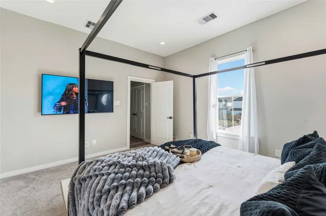 a bedroom with a bed and a painting on the wall