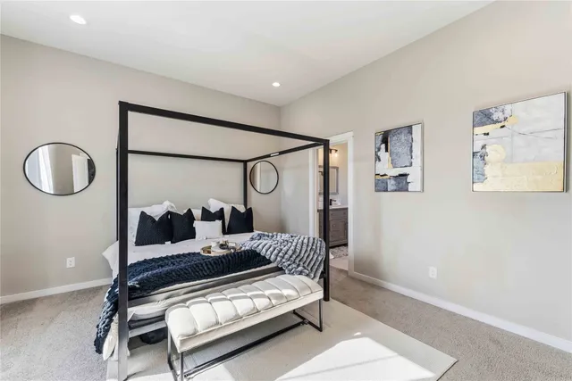 a bedroom with bed and a mirror