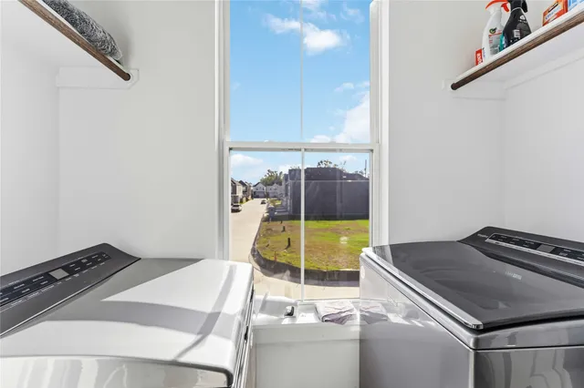a kitchen with a stove and a view of living room