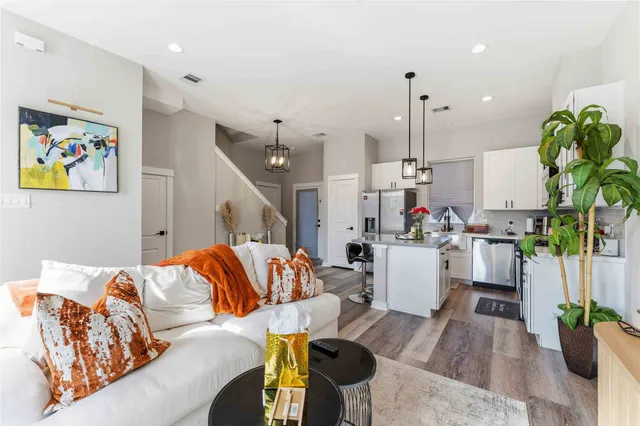 a living room with furniture and a chandelier