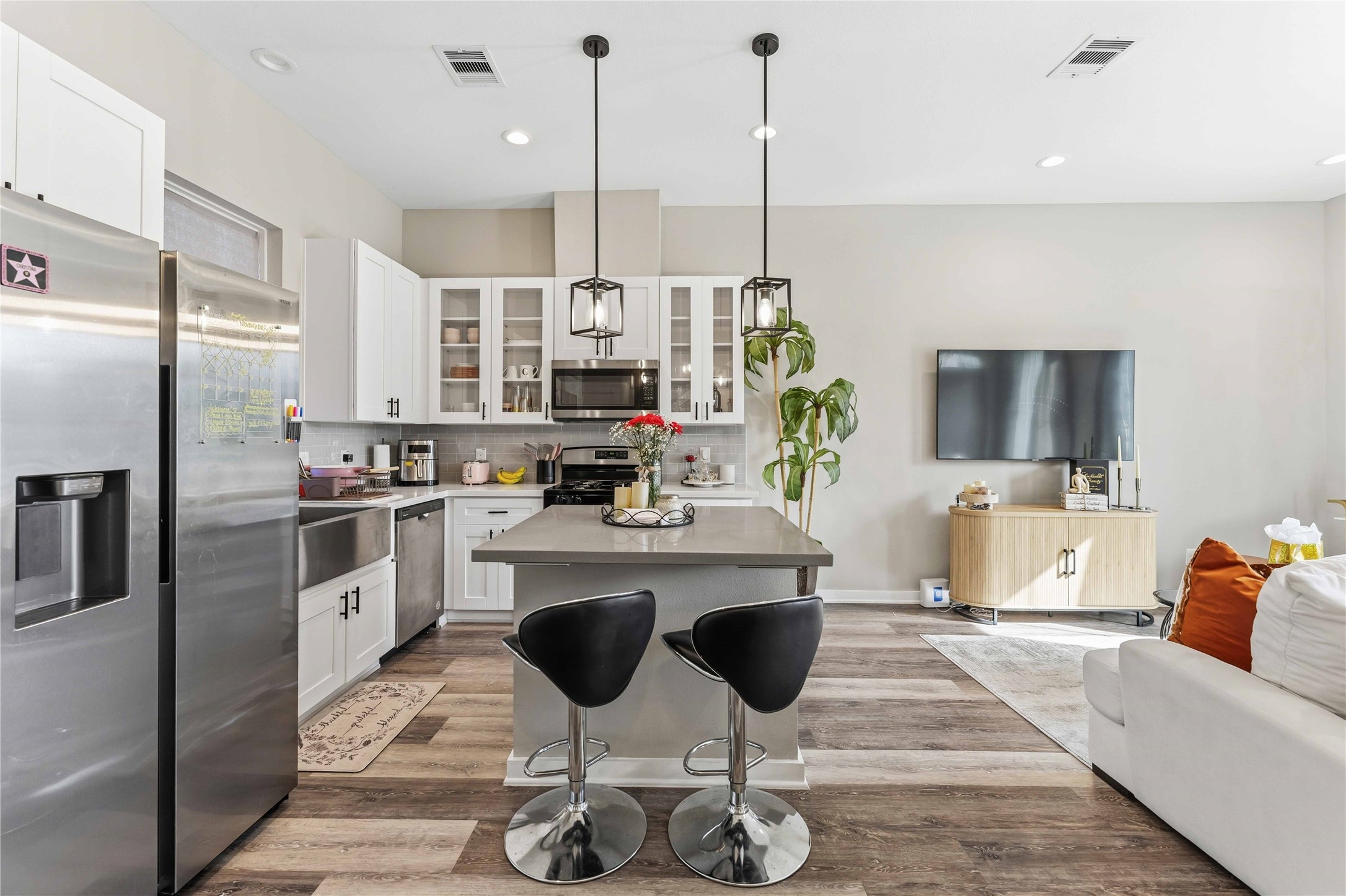 405 Stonework Garden Lane Houston, TX 77076 - Photo 6 of 23 a kitchen with stainless steel appliances kitchen island granite countertop a stove a sink and a refrigerator