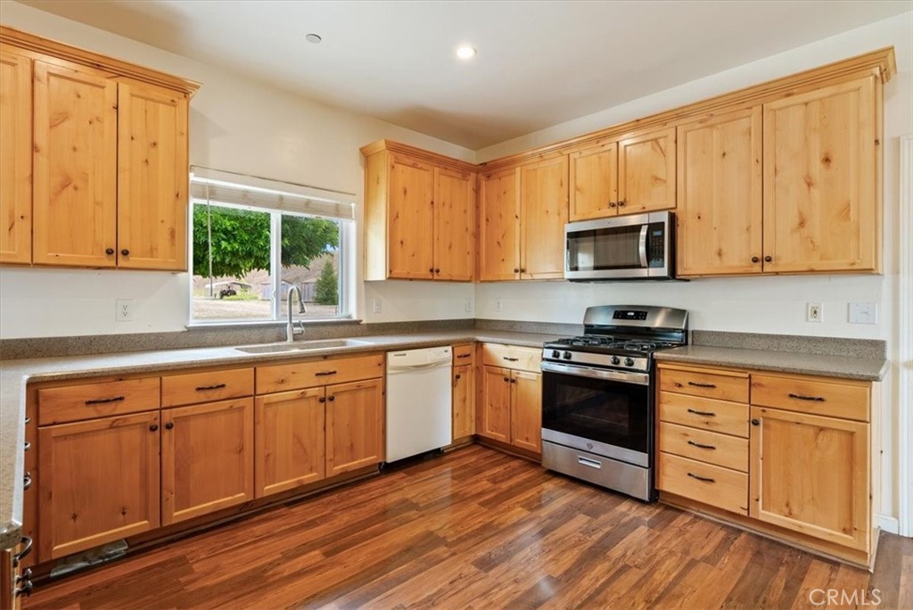 76846 Ranchita Canyon Road San Miguel, CA 93451 - Photo 14 of 51 a kitchen with stainless steel appliances granite countertop wooden cabinets a stove a sink and a window
