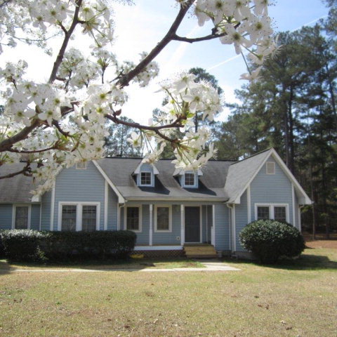 a front view of a house with a yard